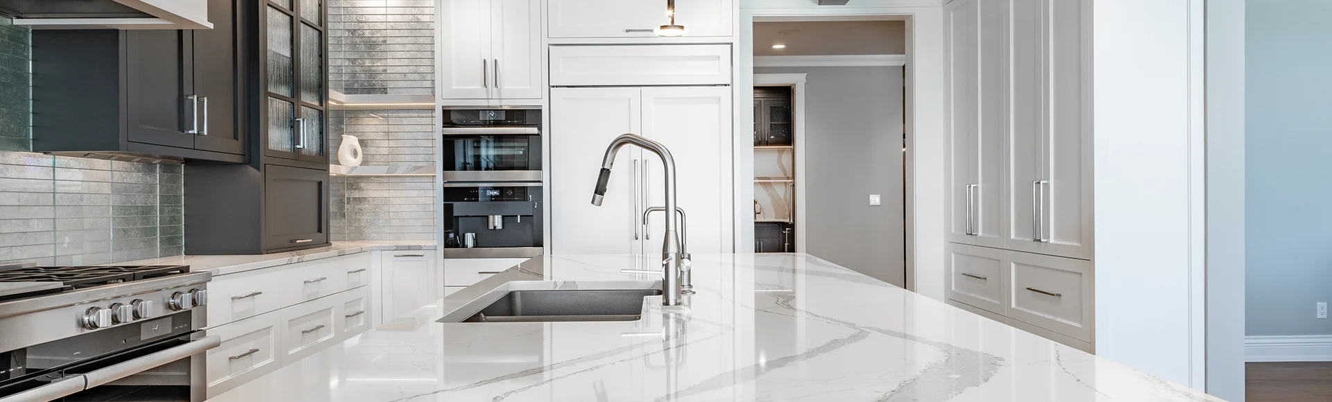 A polished luxurious kitchen with white marble countertop