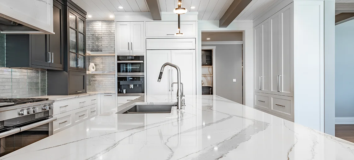 A polished luxurious kitchen with white marble countertop