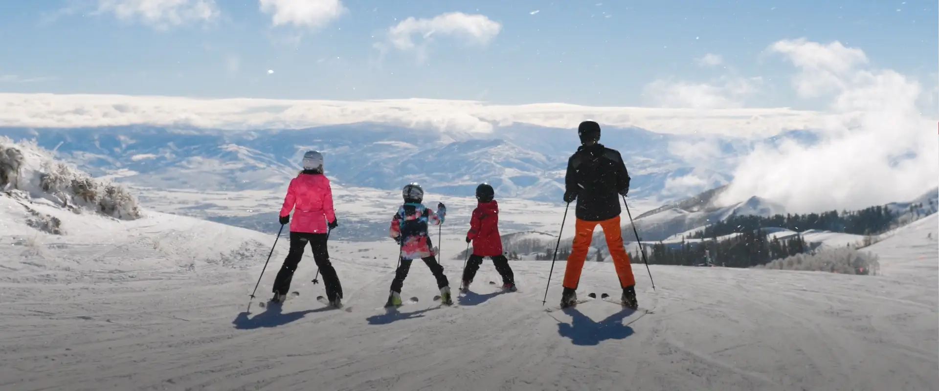 A family of four skiing together